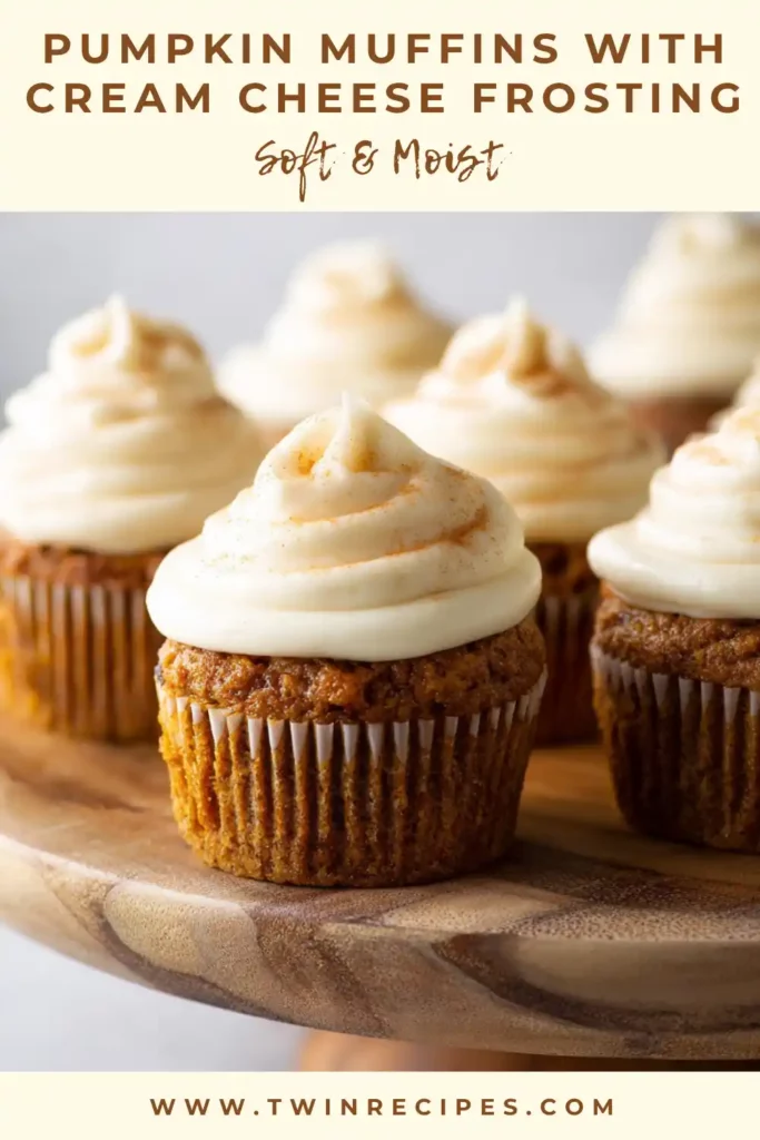 Close-up of frosted pumpkin muffins with swirl of cream cheese topping.
