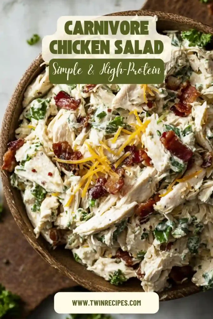 Low-carb carnivore chicken salad in a bowl with cheddar and herbs, featuring turkey bacon for a lighter take on classic chicken salad recipes.