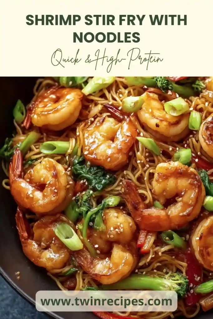 Stir fry bowl filled with shrimp, noodles, vegetables and sesame seeds.